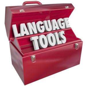 Language Tools words in a red metal toolbox to illustrate educational and learning methods and systems for understanding a foreign or international dialect